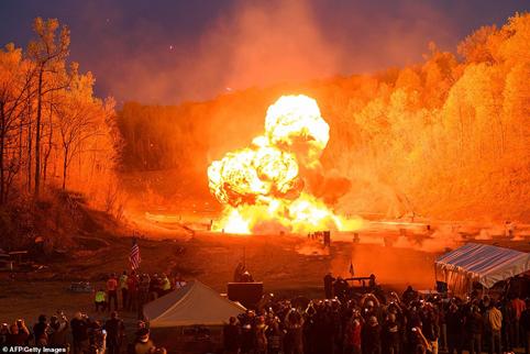 An explosion goes off at the start of the night shoot on the main firing line at the Knob Creek Machine Gun Shoot and Military Gun show in Bullitt County near West Point, Kentucky on April 12
